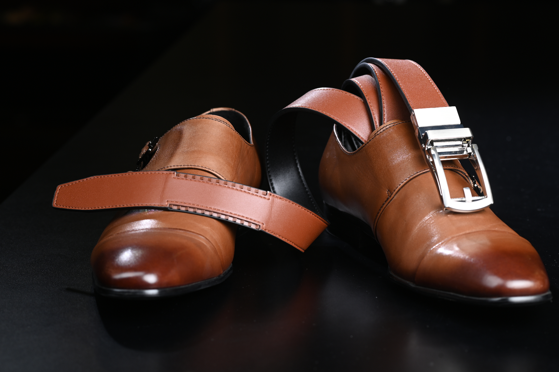 JackRatchet belt wrapped around brown leather shoes showing reversible brown side