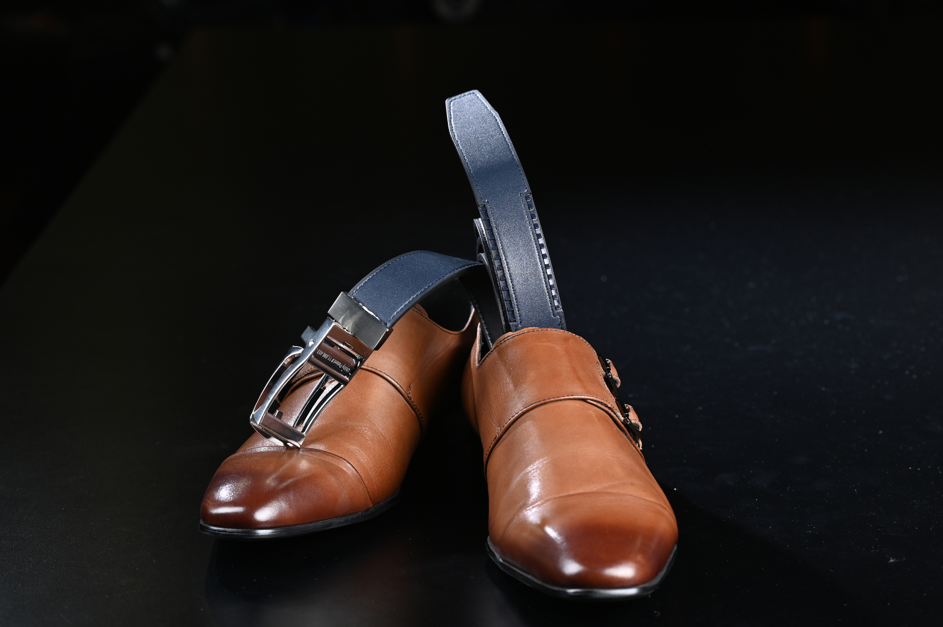 JackRatchet belt on brown shoes showing the black side with ratchet track