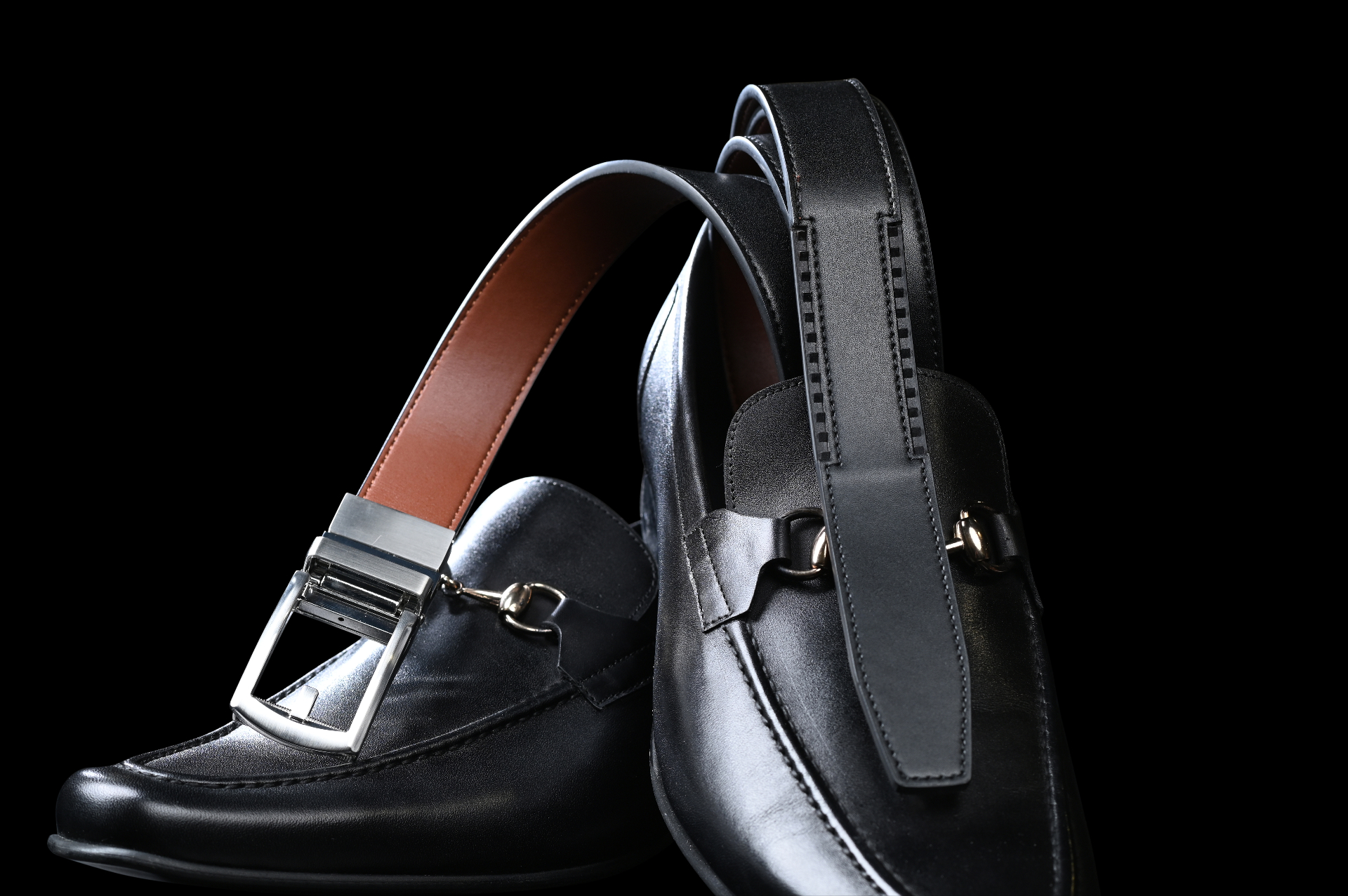 JackRatchet belt on black loafers showing reversible black-to-brown design